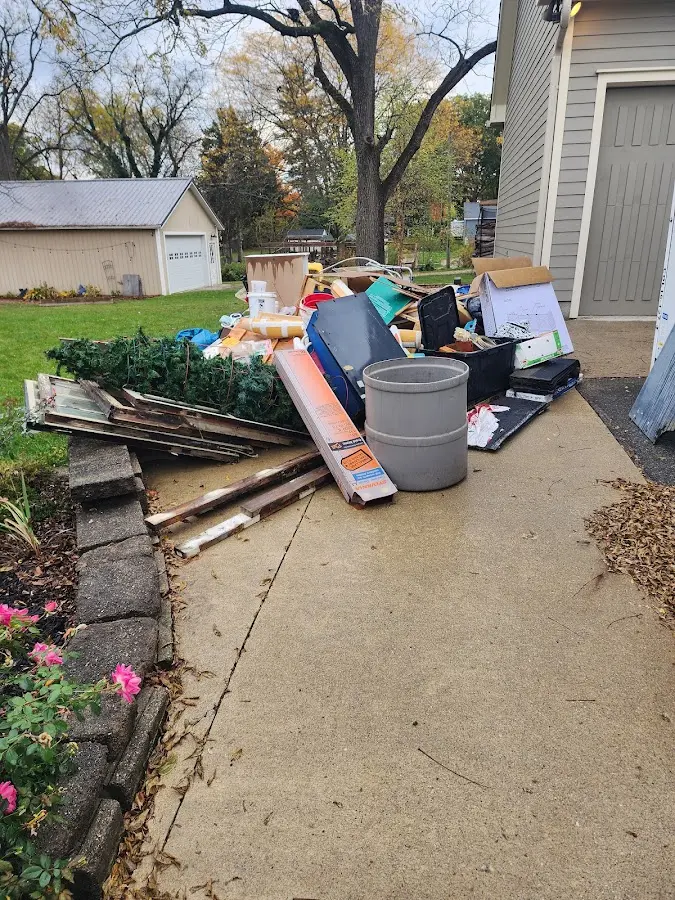 Dumpster being loaded with debris for Roofing Dumpster Rental in Wisconsin Dells